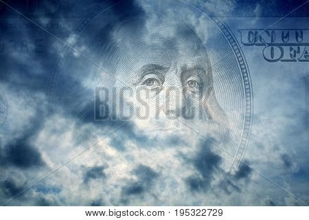 conceptual image of one hundred US dollar bill in cloudy sky