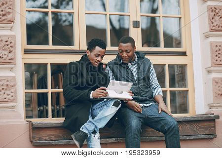handsome men in autumn city with tablet