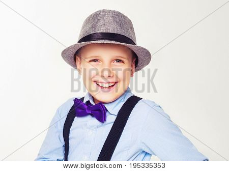 happy child wearing a hat, isolated against white