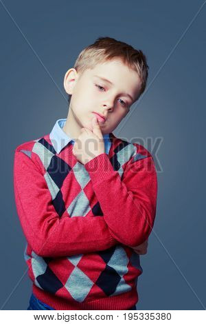 thoughtful sad boy isolated against grey background