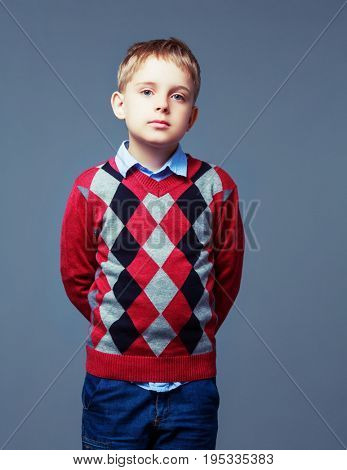nautral emotion on the face of a boy isolated against grey background