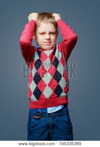 unhappy angry boy isolated against grey background