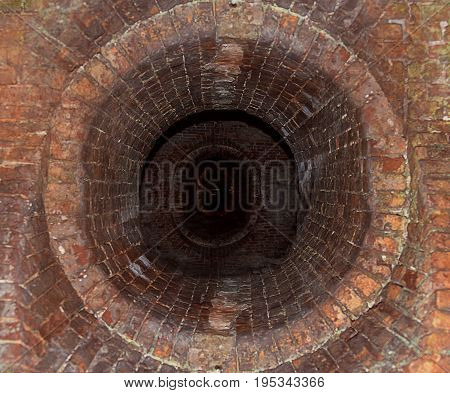 Dark long corridor lined with bricks old passage into the network of tunnels