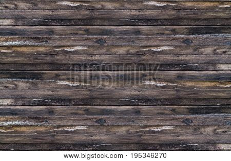 Background stacked stack of dark brown weathered boards