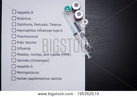 Doctor are checking his patient's Vaccination schedule.