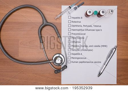 Doctor are checking his patient's Vaccination schedule.