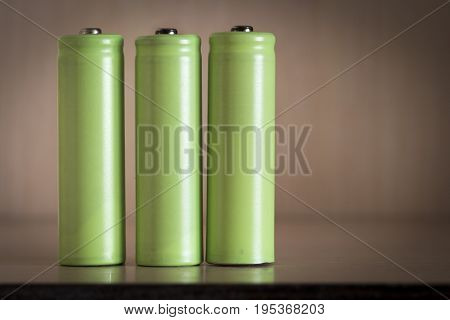 The tree green electric batteries close up.