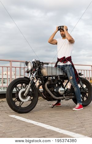 Brutal Man Near His Cafe Racer Custom Motorbike.