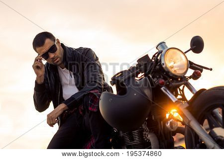 Brutal Man Sit On Cafe Racer Custom Motorbike.