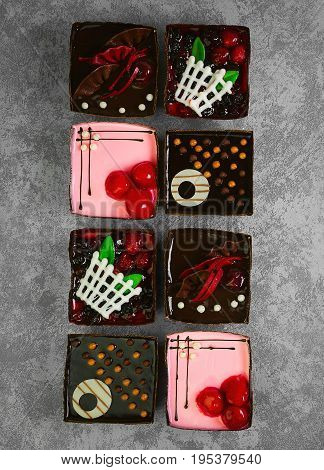 Different pastries tasty assortment. Dessert tray assorted top view background. Cakes, bright, colorful pastry sweets with fresh berries. French Bakery pattern. Flat lay. Blank space.