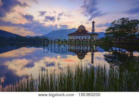 Mirror Reflection Of Beautiful Mosque During Sunrise.