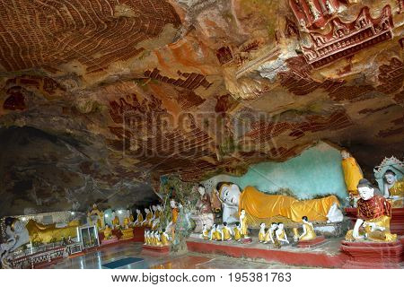 Beautiful View Inside Kawgun Cave In Hpa-an, Myanmar. A Lot Of Various Buddha Statues And Ancient St