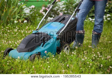 Closeup of grassmower moving on the grass