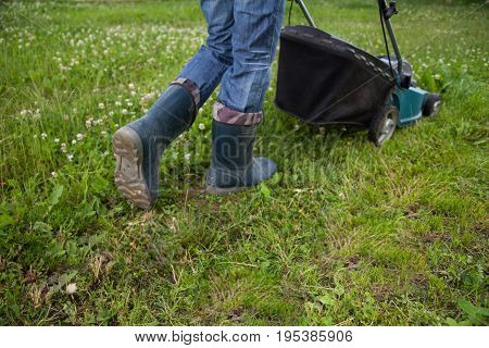 Closeup of grassmower moving on the grass