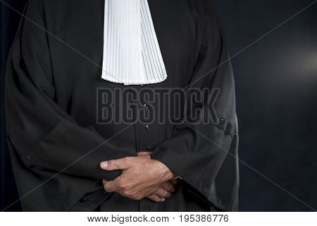 Lawyer in black gown with white jabot hands close up judge