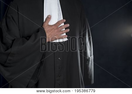 Lawyer in black gown with white jabot hands close up judge