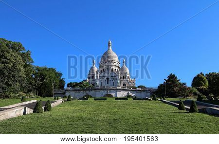 The basilica Sacre Coeur is a Roman catholic church located at the summet of the butte Montmartre , the highest point in Paris.