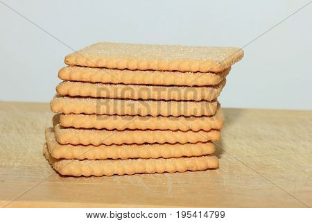 Stacked plain bisuits on a wooden cutting board