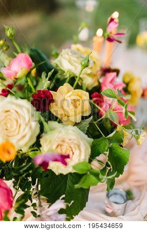 celebration, decoration, wedding, floral design, gardening concept - bright multicolored bouquet of creamy avalanches, yellow roses, beautiful peonies and marasala colored carnations