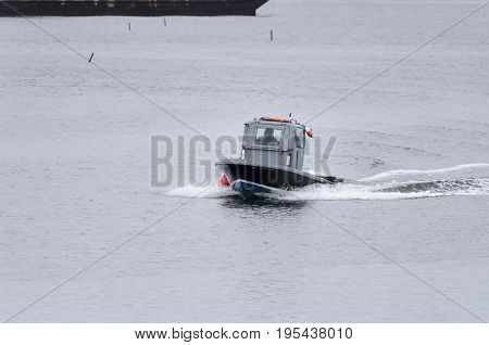 New Bedford Massachusetts USA - January 9 2016: Small fishing boat crossing New Bedford harbor