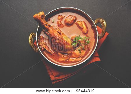 Indian spicy Chicken curry or masala chicken with prominent leg piece, popular recipe from India, selective focus