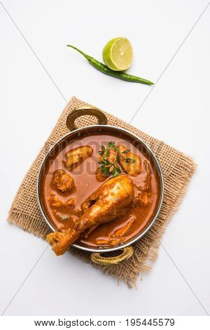 Indian spicy Chicken curry or masala chicken with prominent leg piece, popular recipe from India, selective focus
