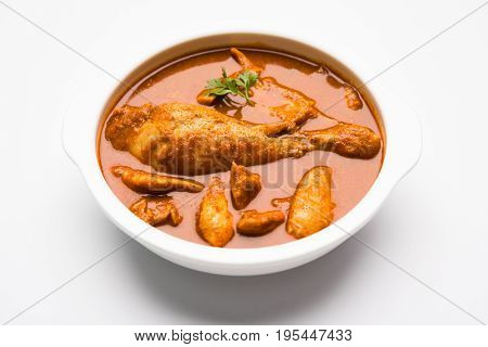 Indian spicy Chicken curry or masala chicken with prominent leg piece, popular recipe from India, selective focus