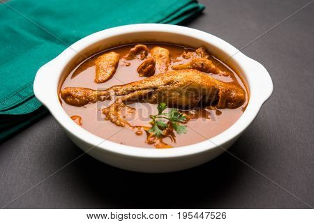 Indian spicy Chicken curry or masala chicken with prominent leg piece, popular recipe from India, selective focus