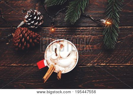 Christmas background - Cup of hot chocolate on wood table with rustic decoration and copy space flat lay top view. vintage color tone style.