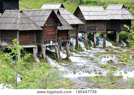 Wooden huts housing the traditional watermills at Pliva Lake Jajce Bosnia and Herzegovina