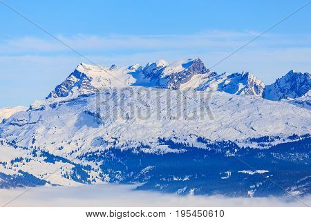 Summits of Alps in Switzerland - wintertime view from the Fronalpstock mountain in the Swiss canton of Schwyz.