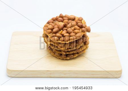 On wooden board Homemade peanut crispy cookie on white background