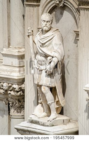 Statue of Francesco Maria I della Rovere Duke of Urbino on the exterior of the Doge's Palace in Venice Italy. The former soldier was sculpted in 1587 by Giovanni Bandini wearing a Roman uniform with an imperial eagle handle on his sword.