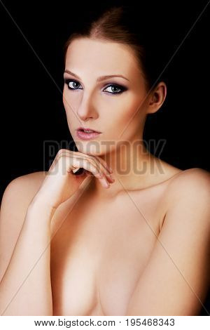 Attractive blonde topless woman with dark make up