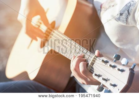 woman's hands playing acoustic guitar, close up hand