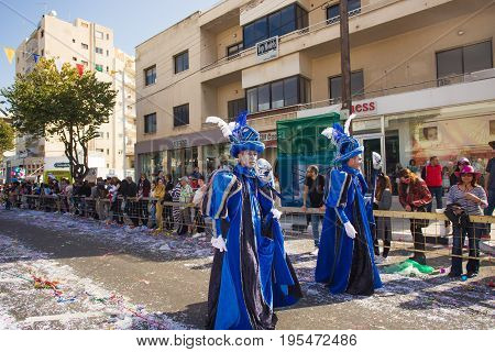 LIMASSOL, CYPRUS - FEBRUARY 26: Carnivalists in a silver cylinder hats joyfully follow the Limassol Municipality Band during the annual Carnival Parade, February 26, 2017 in Limassol.