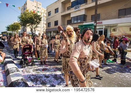 LIMASSOL, CYPRUS - FEBRUARY 26: Carnivalists in a silver cylinder hats joyfully follow the Limassol Municipality Band during the annual Carnival Parade, February 26, 2017 in Limassol.