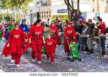 LIMASSOL, CYPRUS - FEBRUARY 26: Carnivalists in a silver cylinder hats joyfully follow the Limassol Municipality Band during the annual Carnival Parade, February 26, 2017 in Limassol.