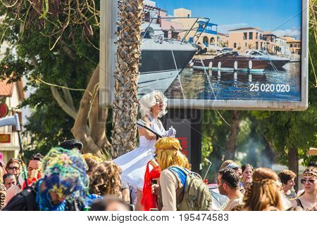 LIMASSOL, CYPRUS - FEBRUARY 26: Carnivalists in a silver cylinder hats joyfully follow the Limassol Municipality Band during the annual Carnival Parade, February 26, 2017 in Limassol.