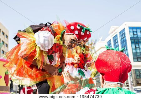LIMASSOL, CYPRUS - FEBRUARY 26: Carnivalists in a silver cylinder hats joyfully follow the Limassol Municipality Band during the annual Carnival Parade, February 26, 2017 in Limassol.