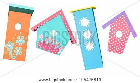 nesting box, painting, handmade concept - colorful bright four birdhouses, kids ornaments from colorful paints on wooden products for wild animals care, isolated on white background
