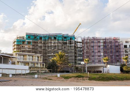 Protaras, Cyprus - February, 15, 2017. Construction's cars working on the construction of a new hotel in Protaras. Urban scene