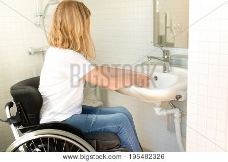 Person In A Wheelchair Washing Hands