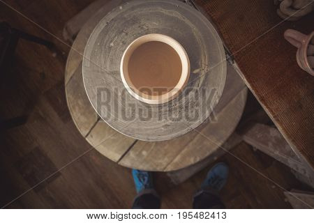 Clay pot on a potter's wheel close-up. Copy spase