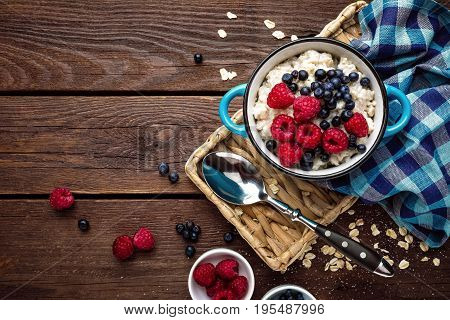 Oatmeal porridge with fresh berries, oats with blueberry and raspberry