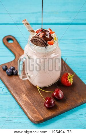 Fresh strawberry milkshake and berries sprinkles chocolate. Healthy Eating concept.