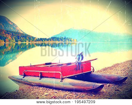 Film Effect. Abandoned Red Gray Fishing Boat On Bank Of Alpine  Lake. Autumnal Morning At  Lake  In