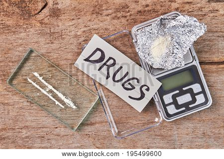 Scales, foil, narcotics, message. Tool for drugs weight, top view.