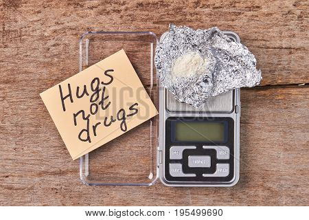 Paper message, digital scales, heroin. Hugs not drugs.