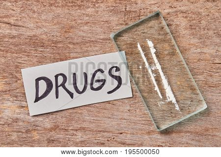 Concept of drugs addiction. Message, narcotics, old wooden background.